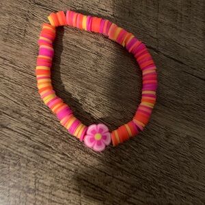 Handmade pink yellow and orange clay bead bracelet with flower charm